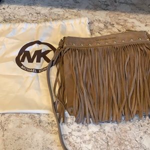 Michael Kors Medium color tan Suede Fringe cross body purse in good condition.
